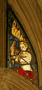 Window depicting a musician angel with a pibcorn by English School